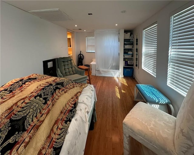 bedroom with recessed lighting and wood finished floors