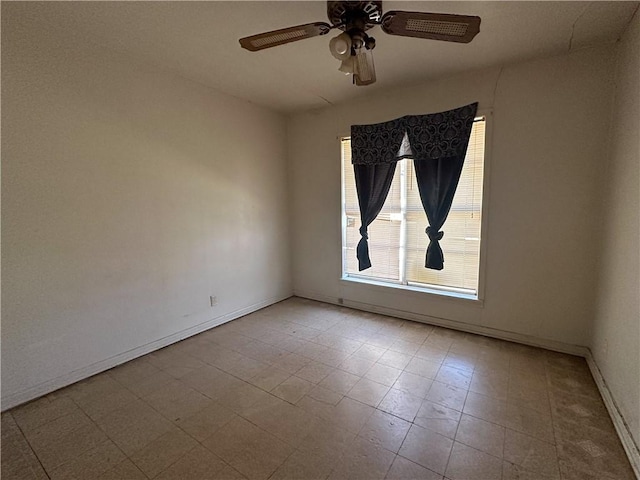 unfurnished room with baseboards, a ceiling fan, and tile patterned floors