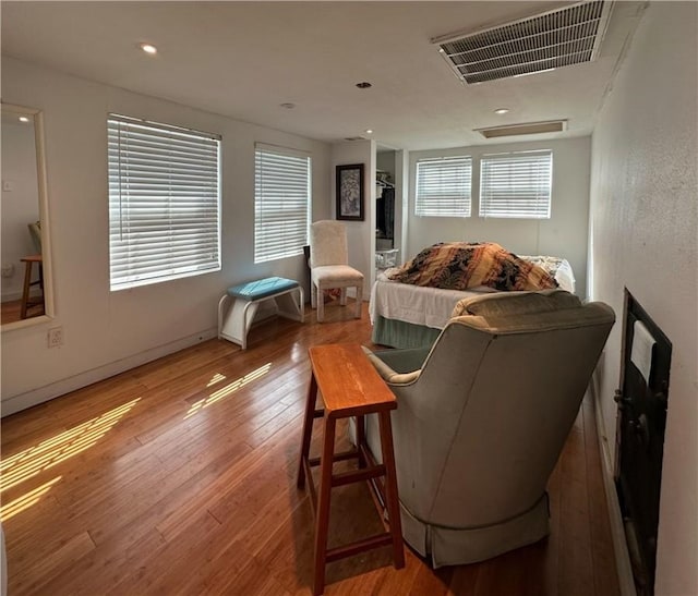 bedroom with hardwood / wood-style flooring and visible vents