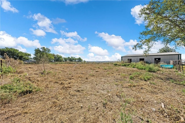 view of yard with an outbuilding and a rural view