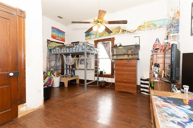 bedroom with dark hardwood / wood-style flooring