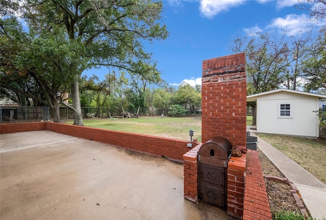 view of patio / terrace with a storage shed and grilling area