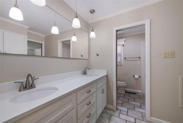 bathroom with vanity, toilet, and ornamental molding