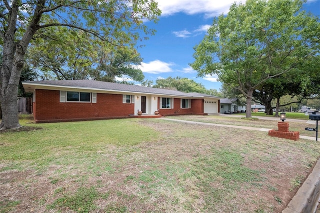 ranch-style house featuring a garage and a front lawn