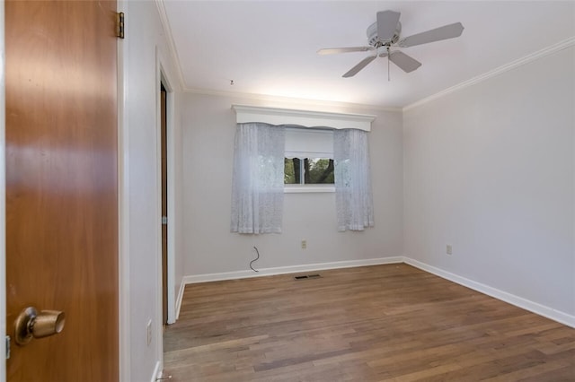 empty room with hardwood / wood-style flooring, ceiling fan, and ornamental molding