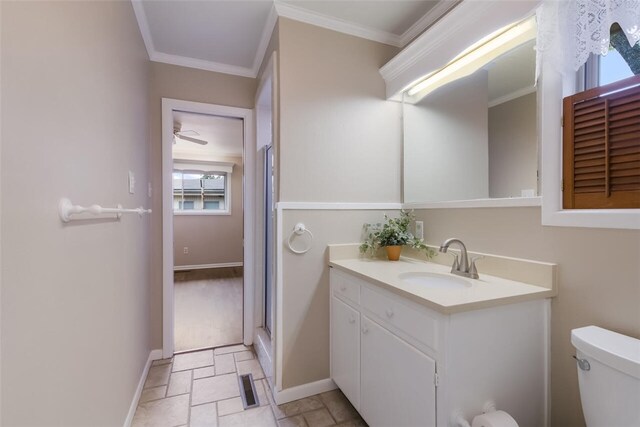 bathroom with vanity, a shower with door, ceiling fan, toilet, and ornamental molding