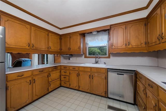 kitchen with appliances with stainless steel finishes, light tile patterned floors, ornamental molding, and sink