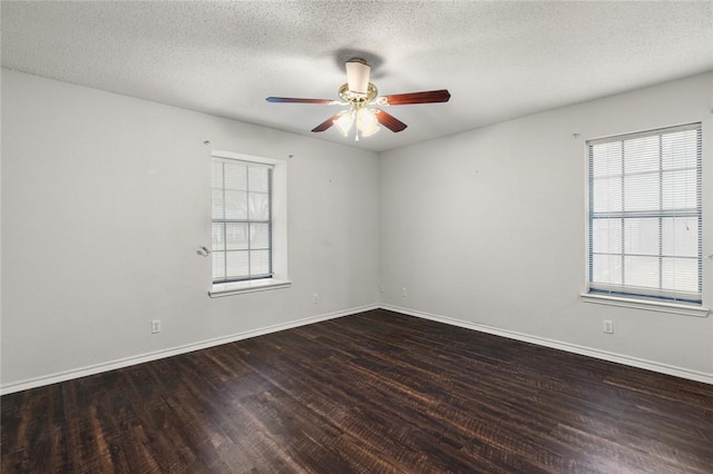 empty room with ceiling fan, dark hardwood / wood-style flooring, and a textured ceiling