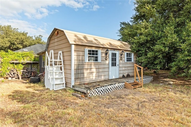 view of outbuilding featuring a yard