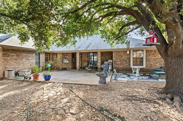 rear view of property featuring a patio