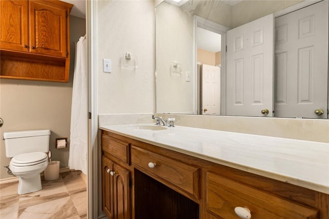 bathroom featuring vanity and toilet