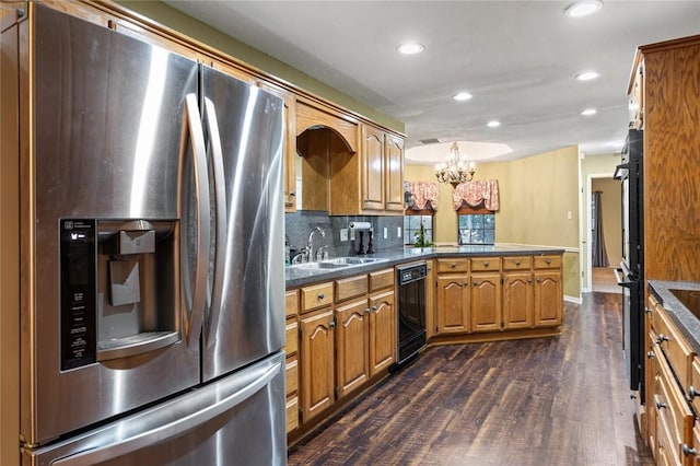 kitchen with sink, an inviting chandelier, dark hardwood / wood-style flooring, decorative backsplash, and appliances with stainless steel finishes