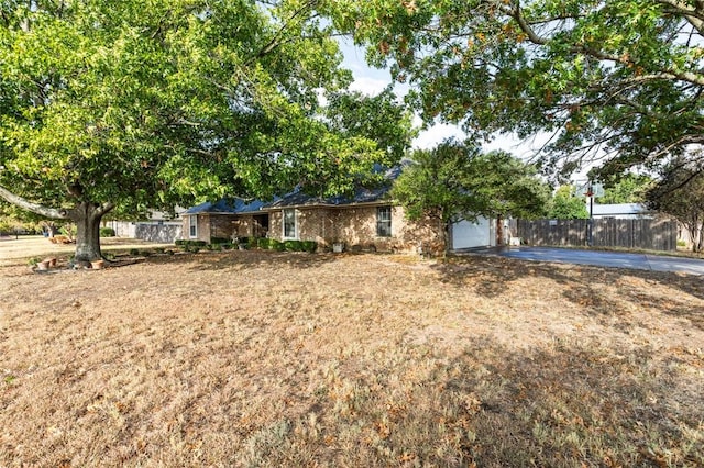 single story home with a garage and a front yard