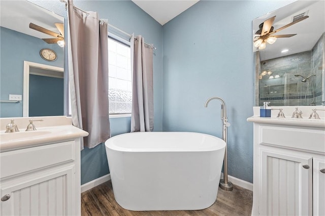 bathroom with vanity, ceiling fan, hardwood / wood-style floors, and plus walk in shower