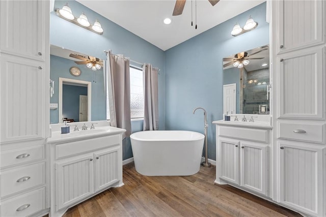 bathroom with vanity, hardwood / wood-style flooring, and ceiling fan