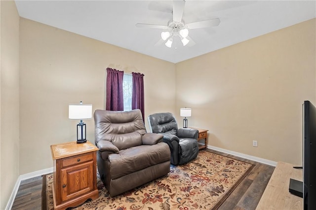 living room featuring ceiling fan and dark wood-type flooring