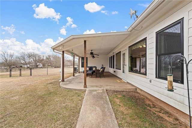 view of yard featuring ceiling fan and a patio