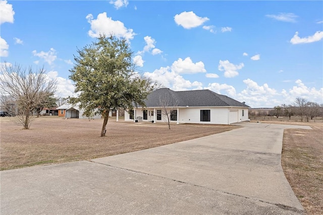 ranch-style home with a garage and a front lawn