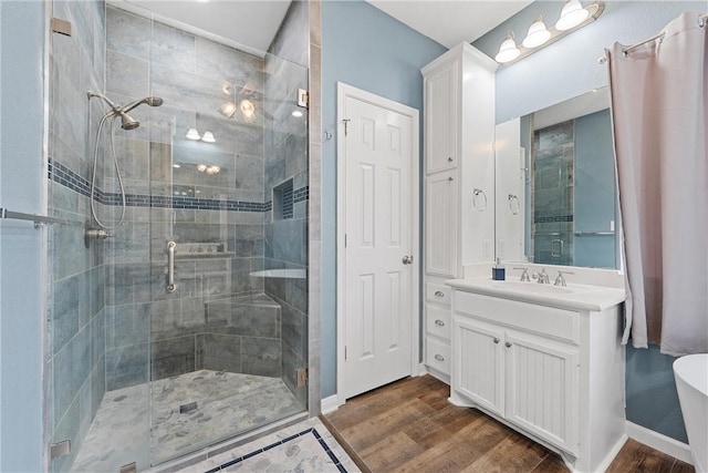 bathroom featuring hardwood / wood-style flooring, an enclosed shower, and vanity