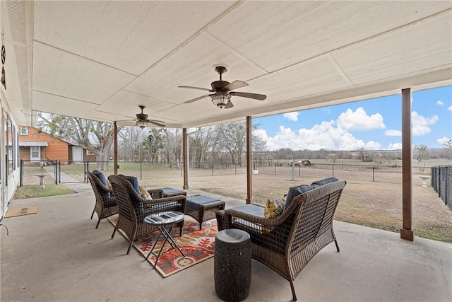 view of patio with an outdoor living space and ceiling fan