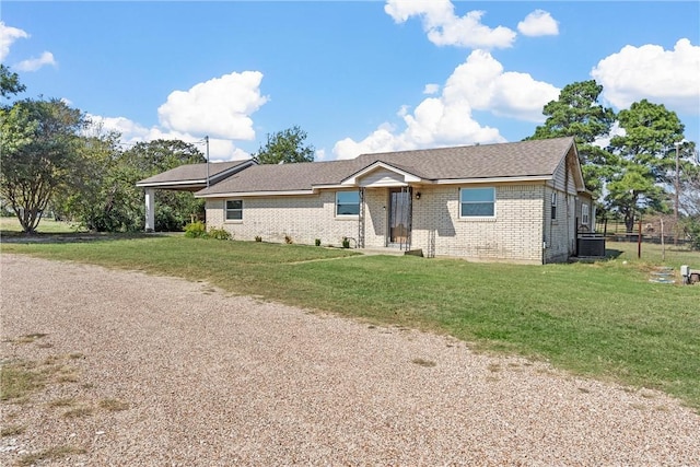 ranch-style house with a front lawn and central AC unit