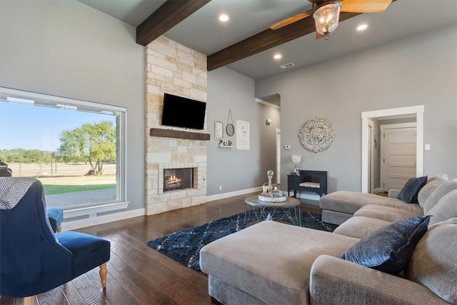 living room with dark hardwood / wood-style floors, ceiling fan, a towering ceiling, a fireplace, and beam ceiling