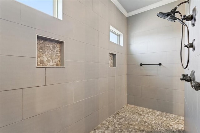 bathroom with tiled shower and ornamental molding