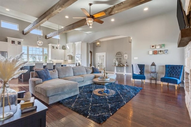 living room with beamed ceiling, dark hardwood / wood-style floors, and ceiling fan