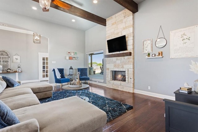 living room featuring ceiling fan, beam ceiling, high vaulted ceiling, a fireplace, and dark hardwood / wood-style floors