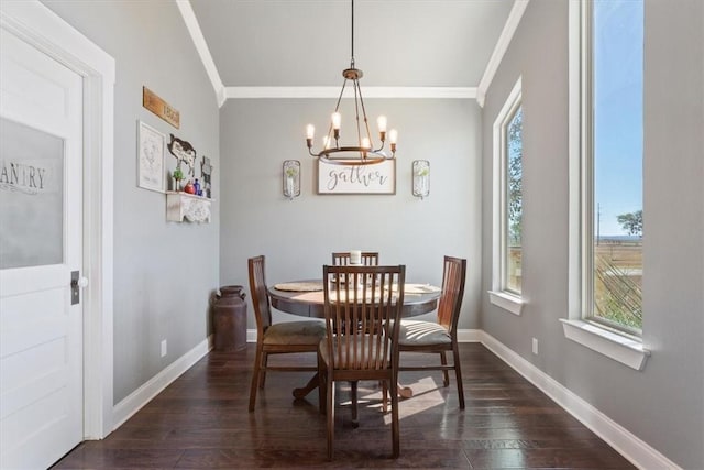 dining space featuring dark hardwood / wood-style flooring, crown molding, plenty of natural light, and a notable chandelier