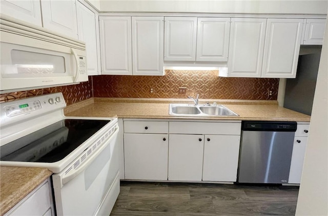 kitchen with decorative backsplash, white appliances, dark wood-type flooring, sink, and white cabinetry