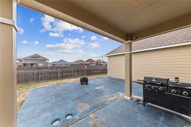 view of patio / terrace with a fenced backyard and a residential view