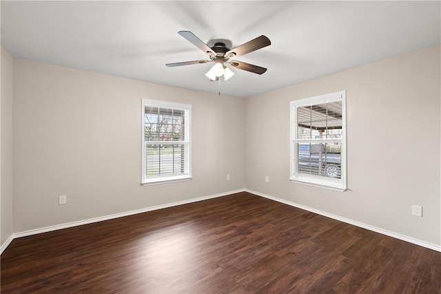 spare room with ceiling fan and dark hardwood / wood-style floors