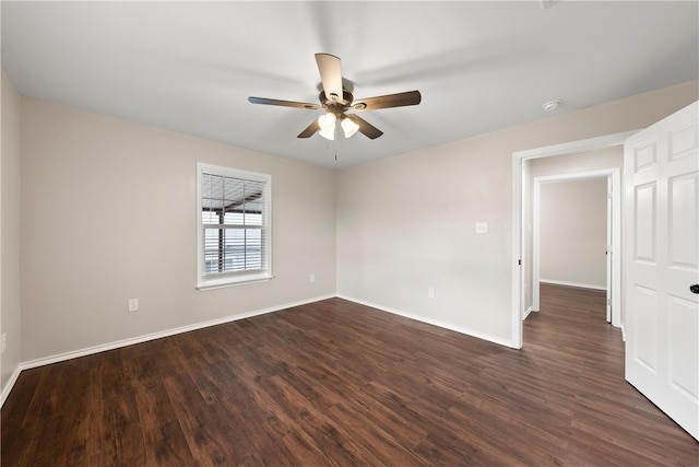 spare room featuring ceiling fan and dark hardwood / wood-style floors