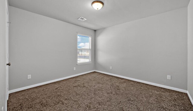 unfurnished bedroom with a spacious closet, a closet, light carpet, and a textured ceiling