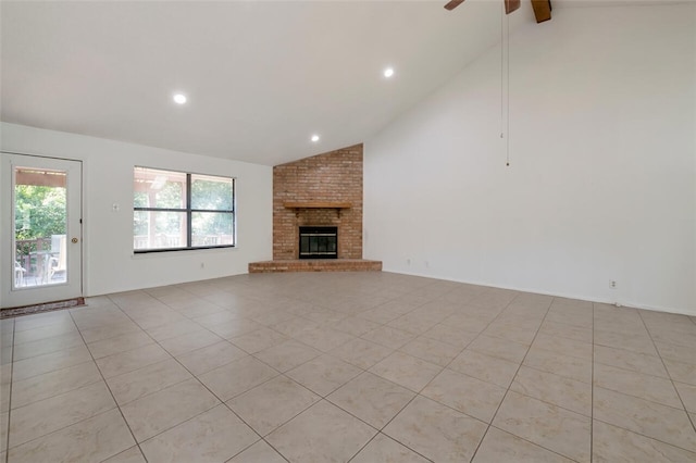 unfurnished living room with high vaulted ceiling, a brick fireplace, ceiling fan, and light tile patterned flooring