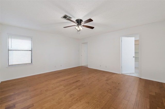 unfurnished room with hardwood / wood-style floors, a textured ceiling, and ceiling fan