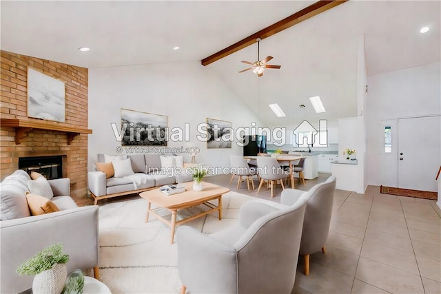 tiled living room featuring ceiling fan, beam ceiling, a fireplace, and high vaulted ceiling