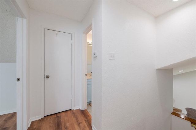 corridor with wood-type flooring