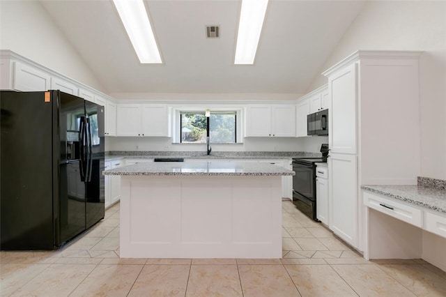 kitchen featuring black appliances, vaulted ceiling, a kitchen island, light stone counters, and white cabinetry