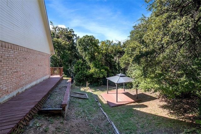 view of yard featuring a gazebo and a wooden deck