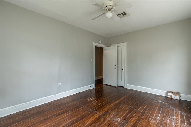 empty room with ceiling fan and dark hardwood / wood-style flooring