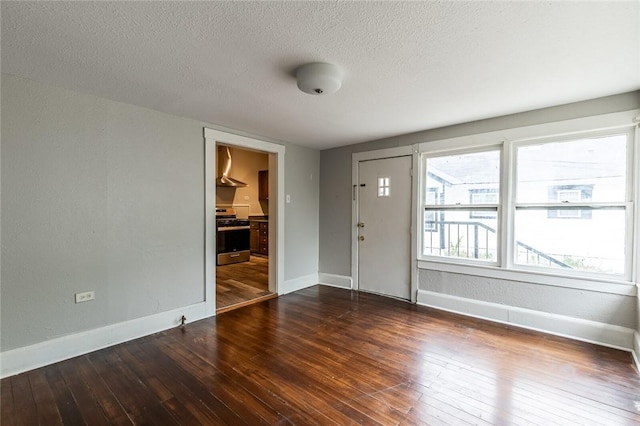 foyer entrance featuring dark hardwood / wood-style flooring and a textured ceiling