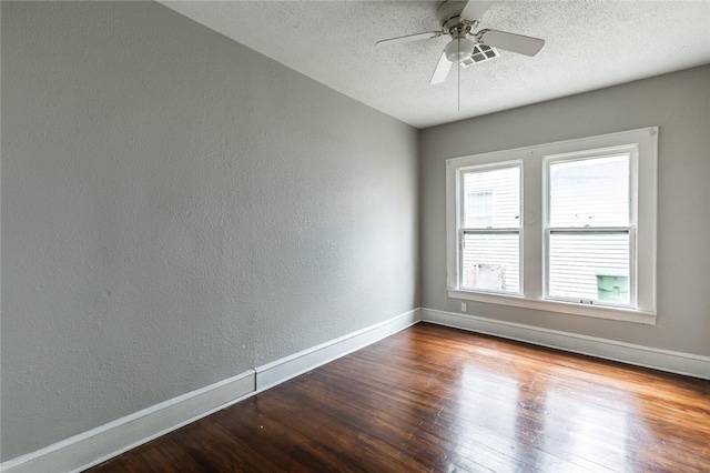 spare room with ceiling fan, wood-type flooring, and a textured ceiling