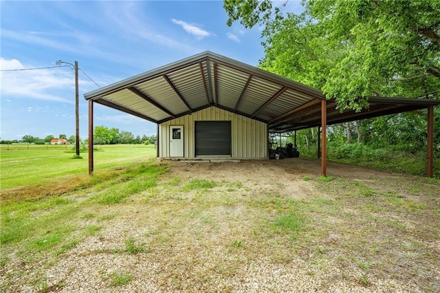 view of pole building featuring a yard and driveway