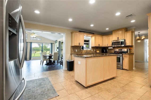 kitchen with a sink, light brown cabinets, backsplash, and stainless steel appliances