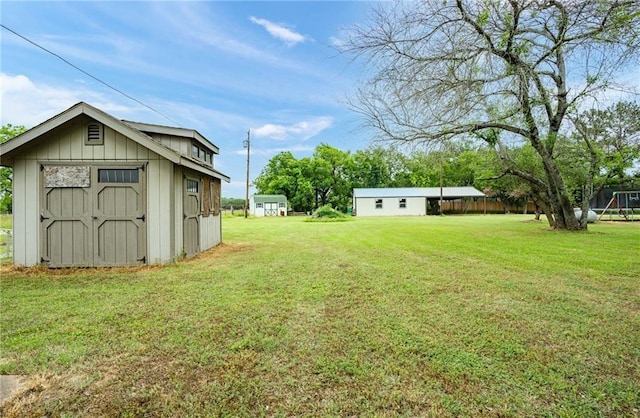 view of yard featuring a storage shed and an outdoor structure