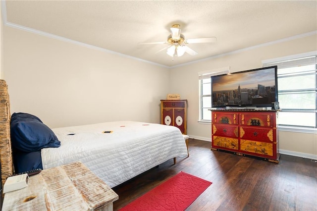 bedroom featuring ceiling fan, baseboards, hardwood / wood-style floors, and crown molding