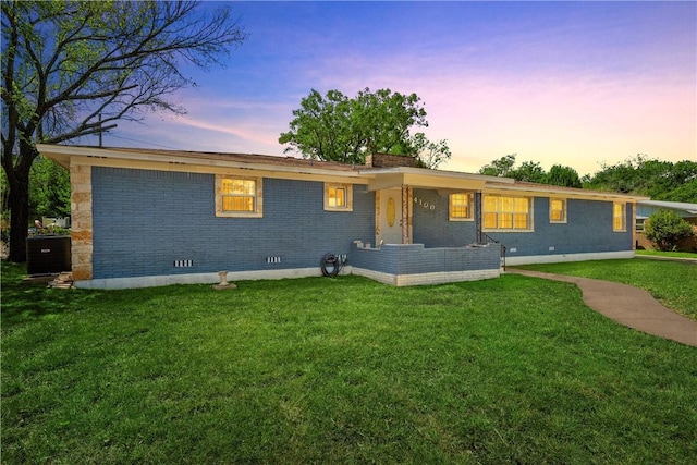 ranch-style home with a lawn