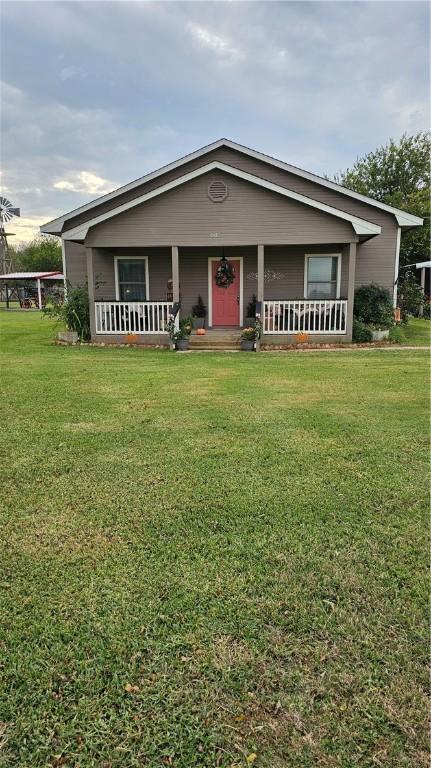 view of front of home featuring a porch and a front lawn